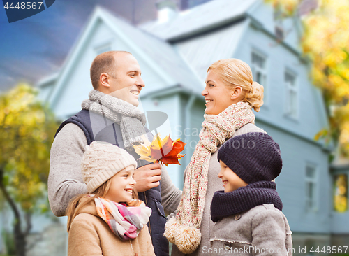 Image of happy family over living house in autumn