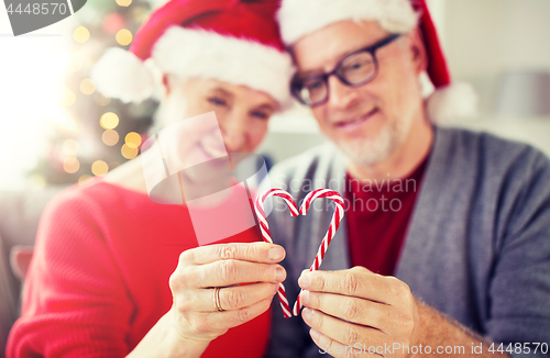 Image of senior couple with heart of christmas candy canes