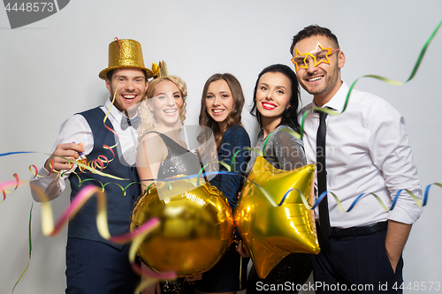 Image of friends with party props and confetti laughing