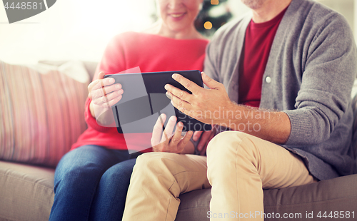 Image of senior couple with tablet pc at christmas