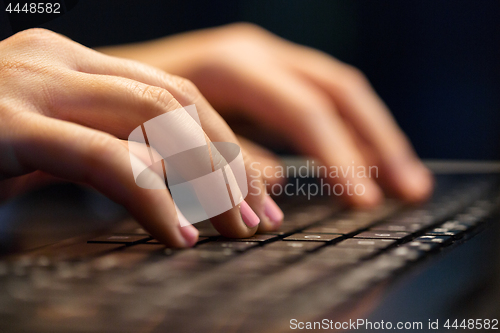 Image of close up of female hands with laptop typing