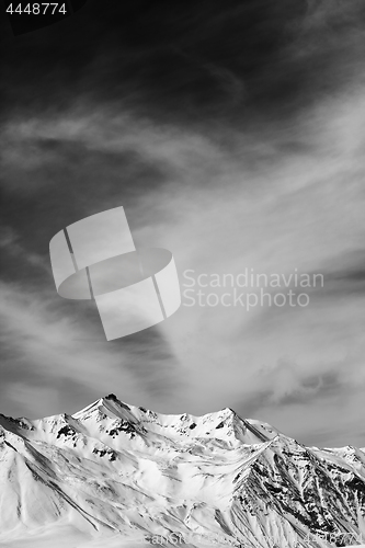 Image of Black and white winter snowy mountains at windy day