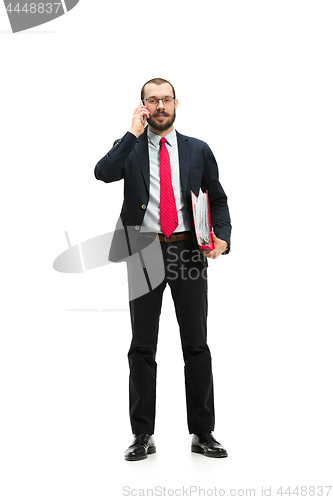 Image of Happy businessman talking on the phone with folder in hand isolated over white background in studio shooting