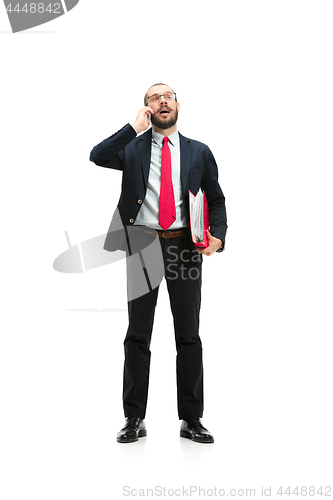 Image of Happy businessman talking on the phone with folder in hand isolated over white background in studio shooting
