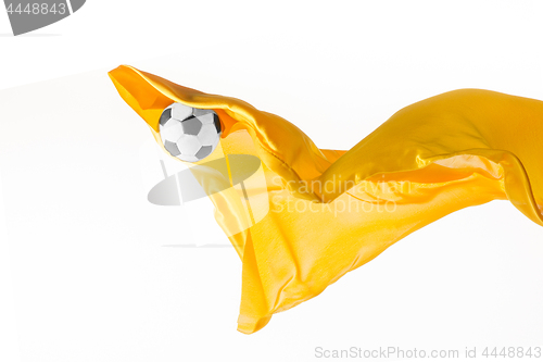 Image of Soccer ball and Smooth elegant transparent yellow cloth isolated or separated on white studio background.