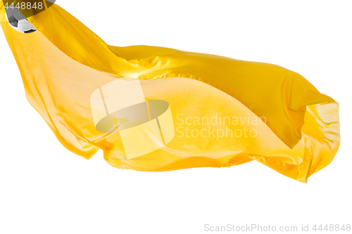 Image of Soccer ball and Smooth elegant transparent yellow cloth isolated or separated on white studio background.