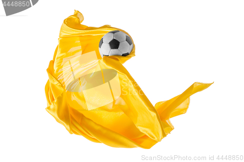 Image of Soccer ball and Smooth elegant transparent yellow cloth isolated or separated on white studio background.