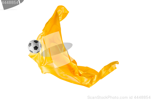 Image of Soccer ball and Smooth elegant transparent yellow cloth isolated or separated on white studio background.