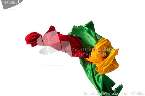 Image of Smooth elegant transparent yellow, red, green cloth separated on white background.
