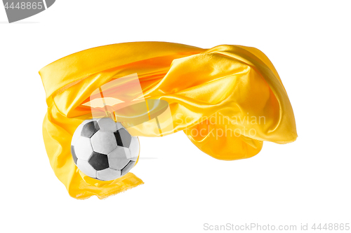 Image of Soccer ball and Smooth elegant transparent yellow cloth isolated