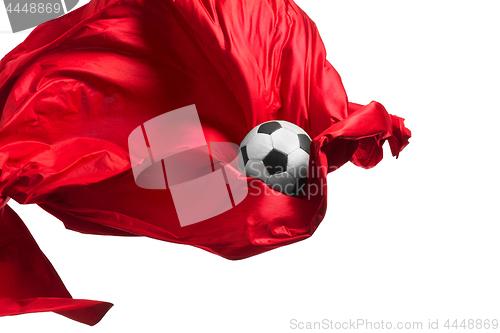 Image of Soccer ball and Smooth elegant transparent red cloth isolated or separated on white studio background.