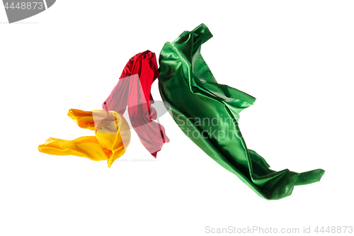 Image of Smooth elegant transparent yellow, red, green cloth separated on white background.