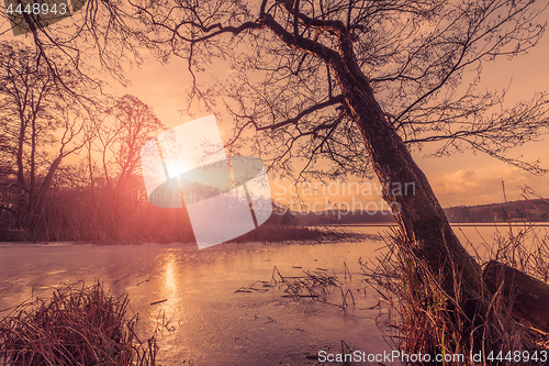 Image of Sunset over a frozen lake in the winter