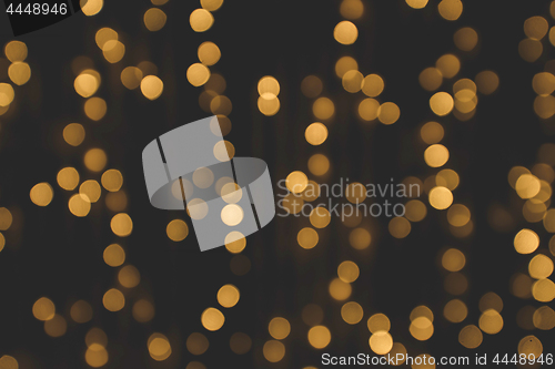 Image of Golden glitter bokeh lights on a dark background