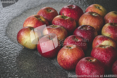 Image of Wet apples on a granite rock in the rain