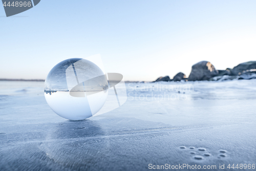 Image of Glass orb on a frozen lake in the winter