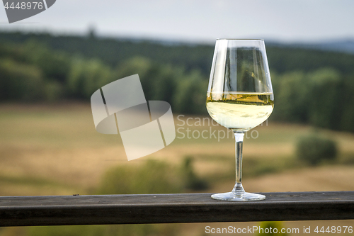 Image of Glass of white wine on a wooden board