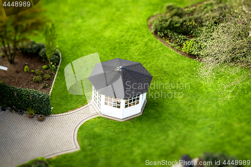 Image of Small pavillon in a garden on a green lawn