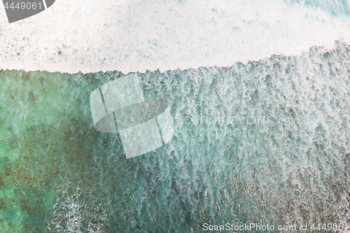 Image of Aerial shot of the braking wave in the ocean.