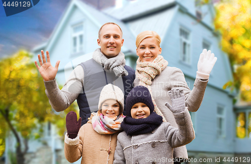 Image of happy family over living house in autumn