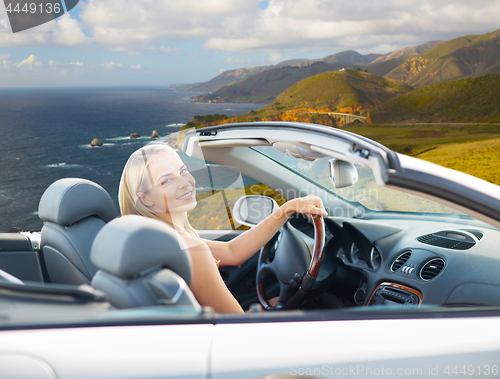 Image of woman driving convertible car on big sur coast