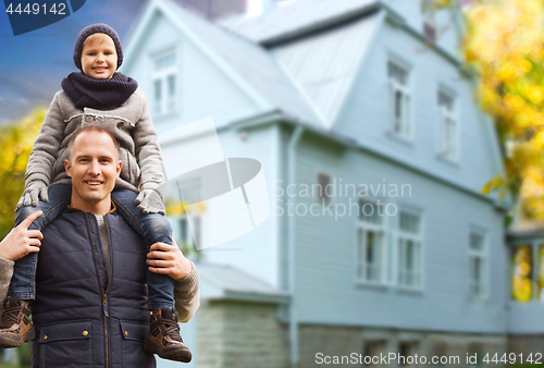 Image of happy father and son over living house in autumn