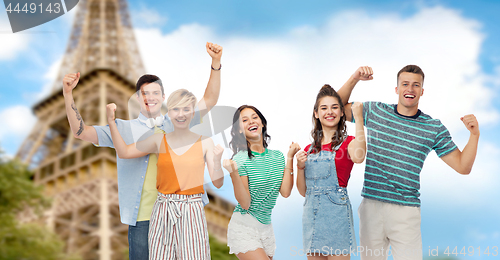 Image of friends making fist pump gesture over eiffel tower