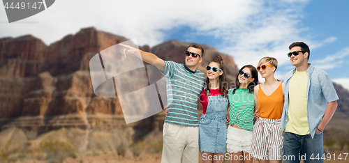 Image of friends in sunglasses over grand canyon