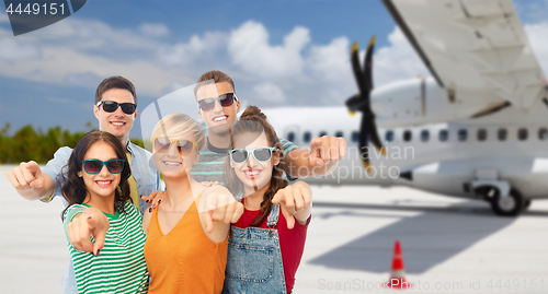 Image of friends pointing at you over plane on airfield