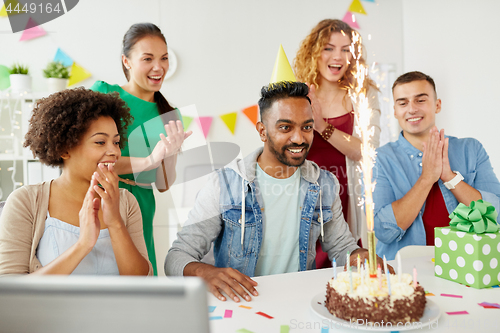 Image of office team greeting colleague at birthday party