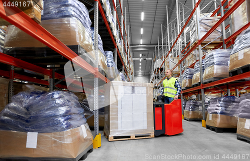 Image of loader operating forklift at warehouse