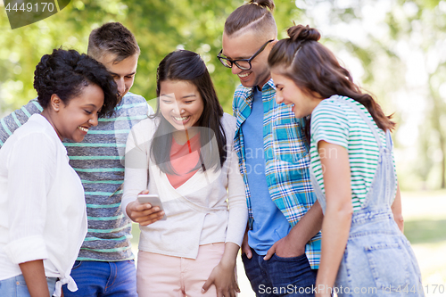 Image of group of happy friends with smartphone outdoors