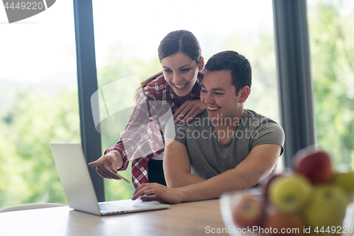 Image of happy young couple buying online