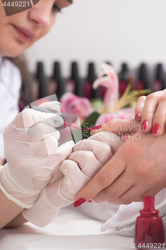 Image of Woman hands receiving a manicure