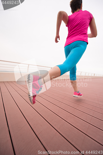 Image of woman busy running on the promenade