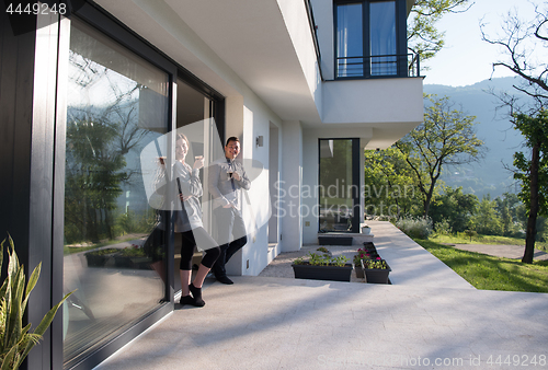 Image of couple enjoying on the door of their luxury home villa