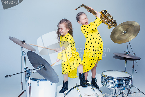 Image of The teen music band performing in a recording studio