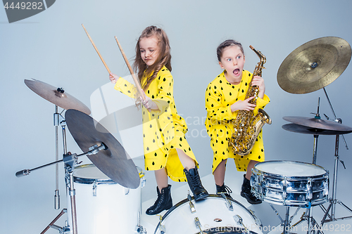 Image of The teen music band performing in a recording studio