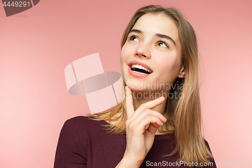 Image of Woman smiling with perfect smile and white teeth on the pink studio background