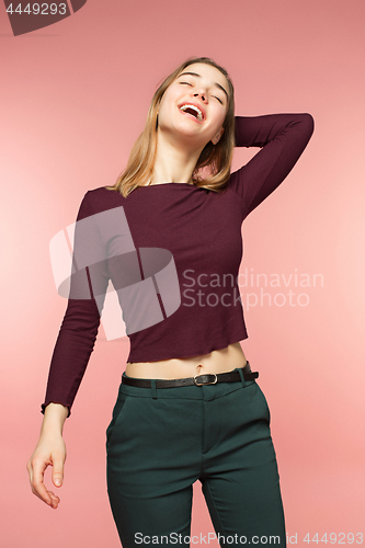 Image of Woman smiling with perfect smile and white teeth on the pink studio background