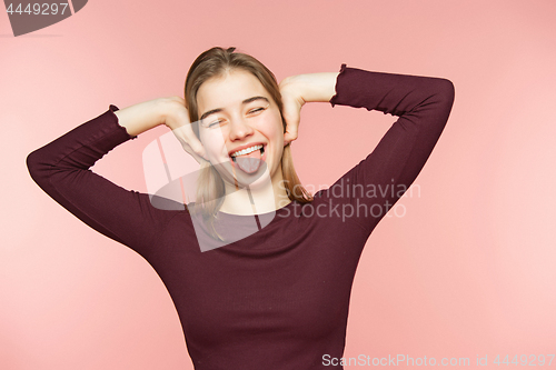 Image of Woman smiling with perfect smile and white teeth on the pink studio background