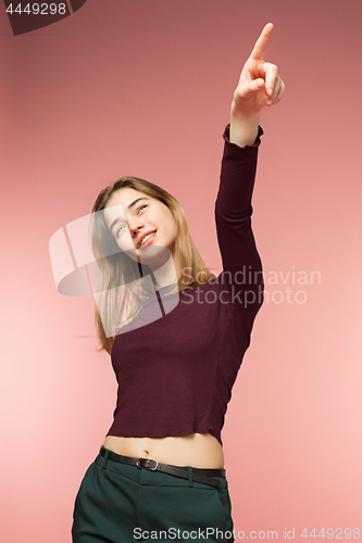 Image of Woman smiling with perfect smile and white teeth on the pink studio background