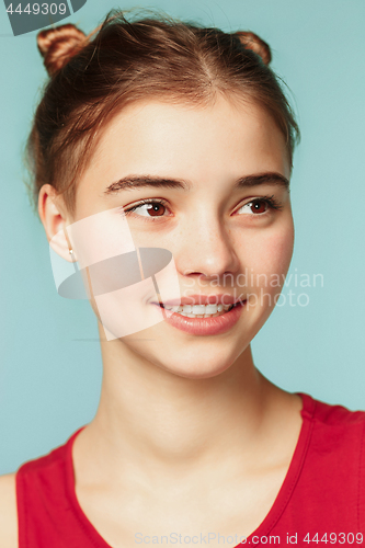 Image of Woman smiling with perfect smile on the blue studio background and looking at camera