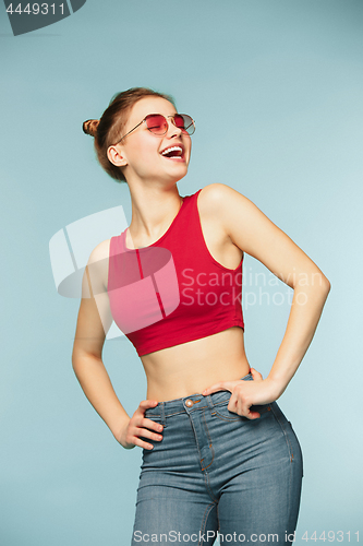 Image of Woman smiling with perfect smile on the blue studio background