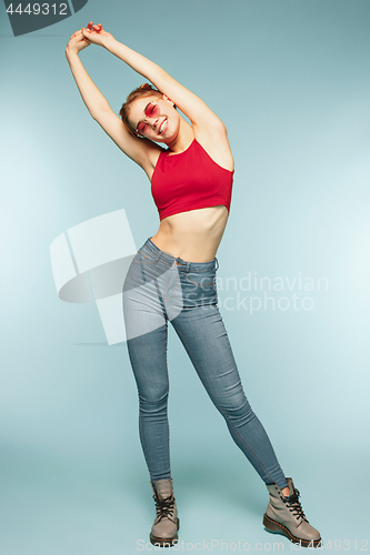 Image of Woman smiling with perfect smile on the blue studio background