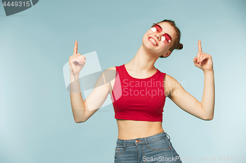 Image of Woman smiling with perfect smile on the blue studio background