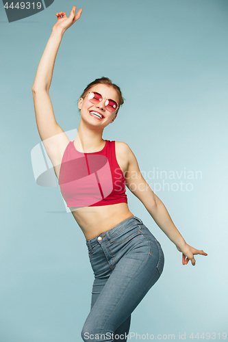 Image of Woman smiling with perfect smile on the blue studio background