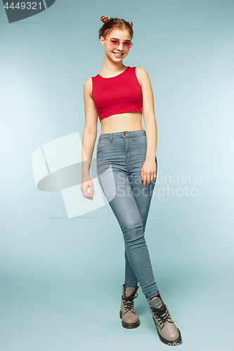 Image of Woman smiling with perfect smile on the blue studio background