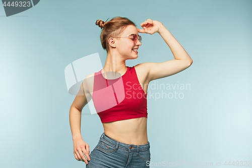 Image of Woman smiling with perfect smile on the blue studio background