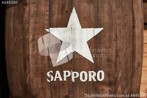 Image of Sapporo beer logo on a barrel